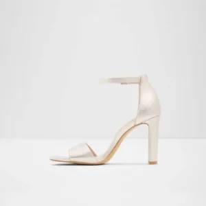 Ivory high heels by Lajwanti Shoes with buckle strap and block heel design.