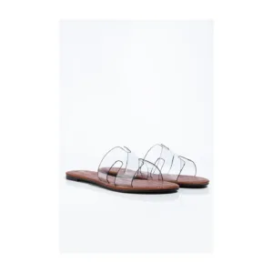 Clear flat shoes by Lajwanti Designers with transparent straps and a sleek wooden sole.