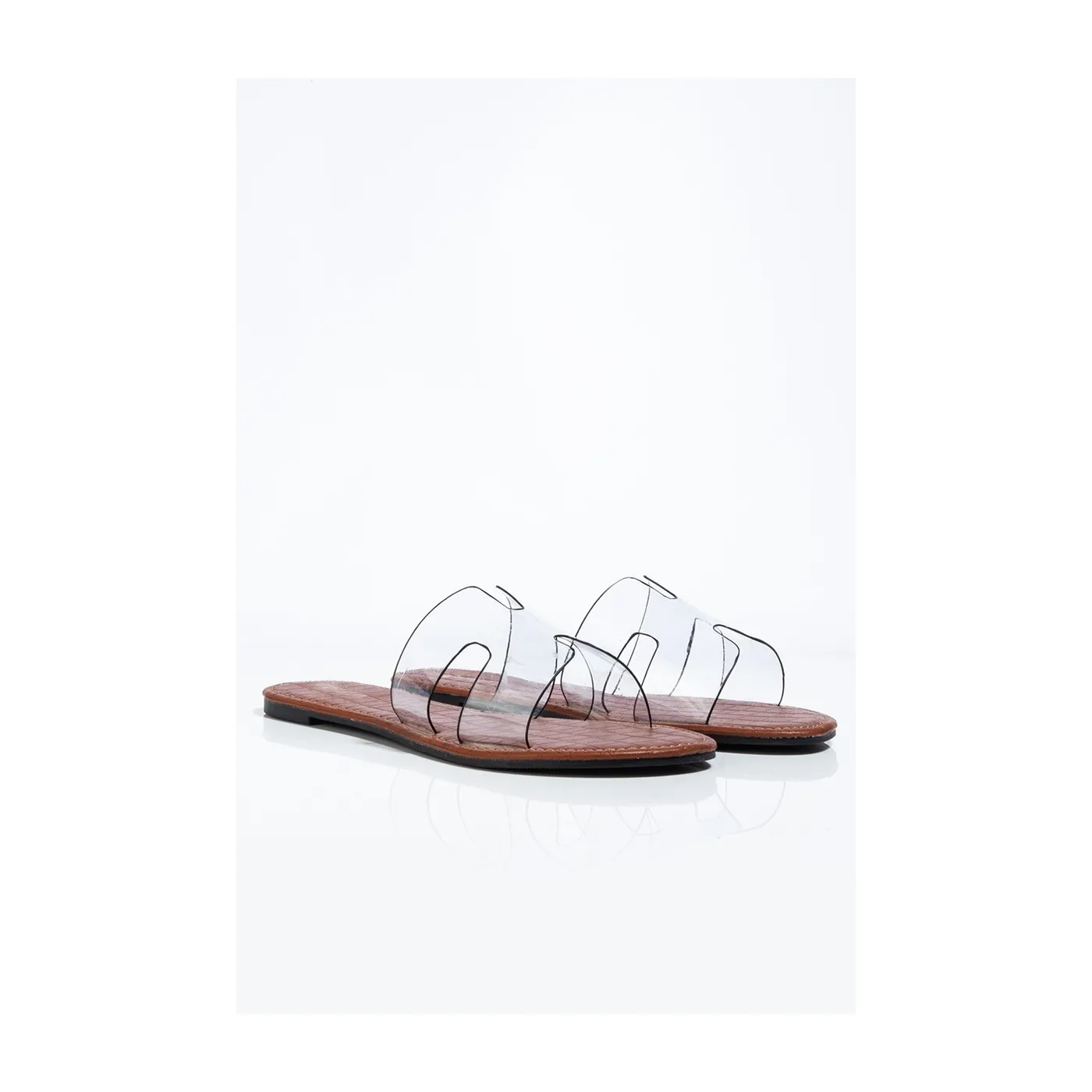 Clear Flat Shoes by Lajwanti Designers – Comfortable Transparent Strap Sandals Clear flat shoes by Lajwanti Designers with transparent straps and a sleek wooden sole.