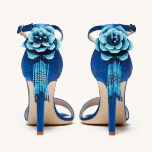Back view of blue satin sandals with floral decoration.