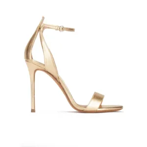 Gold metallic stiletto sandals with slim ankle strap and open toe by Lajwanti Collections.
