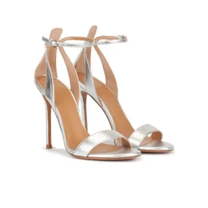 Front view of silver metallic sandals with ankle strap and high heels by Lajwanti Designers.