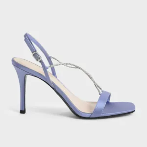 Side view of purple satin sandals with rhinestone straps and high heels by Lajwanti Designers.