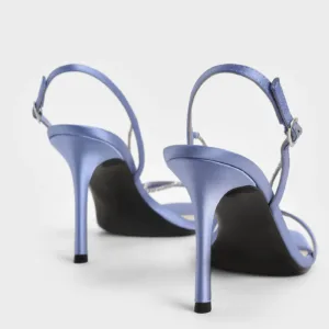 Back view of purple satin sandals with adjustable buckle and high heels by Lajwanti Designers.