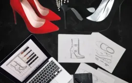 Custom-made red and black high heels with sketches and designs showcasing bespoke footwear craftsmanship.